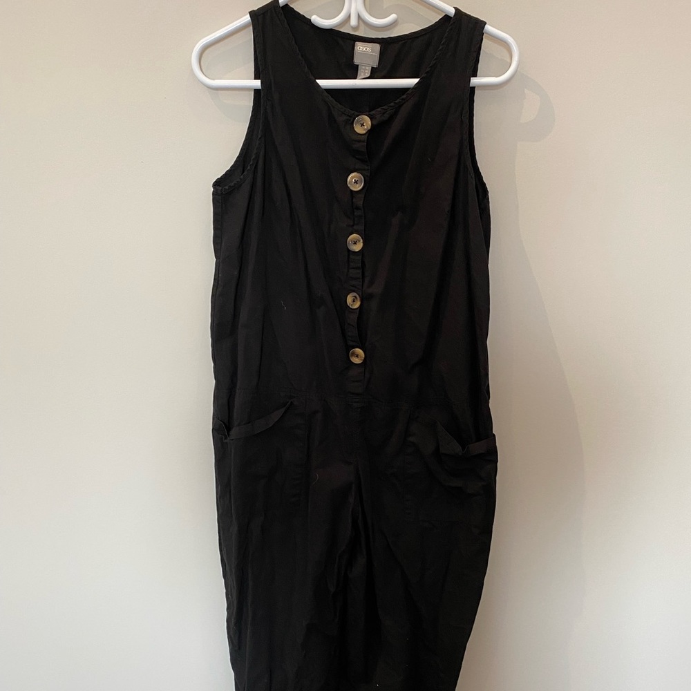 One piece black jumper/romper with pockets.